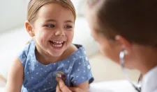 Your Skin - Child with doctor smiling